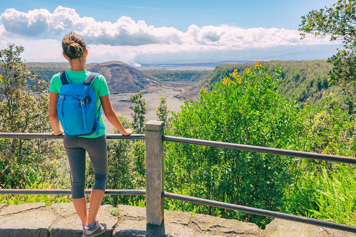 Hawaii student traveler looking at view of Kilauea Iki crater lava field lake in Big Island, Hawaii.