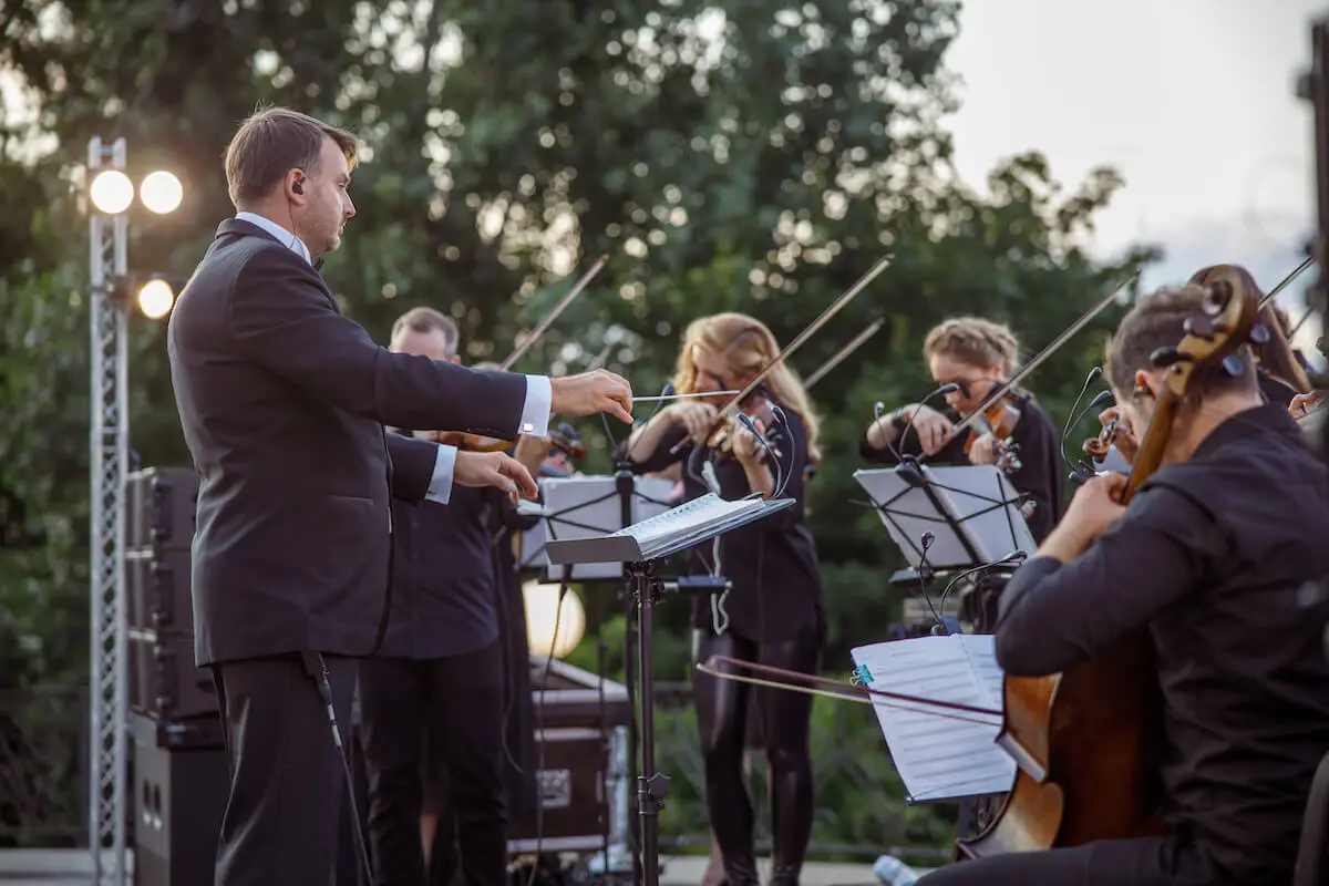 student orchestra ensemble on a stage playing