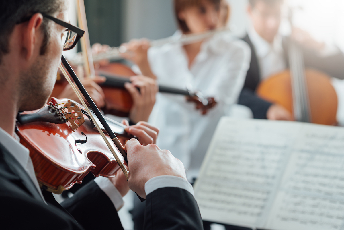 Violinist performing with classical orchestra