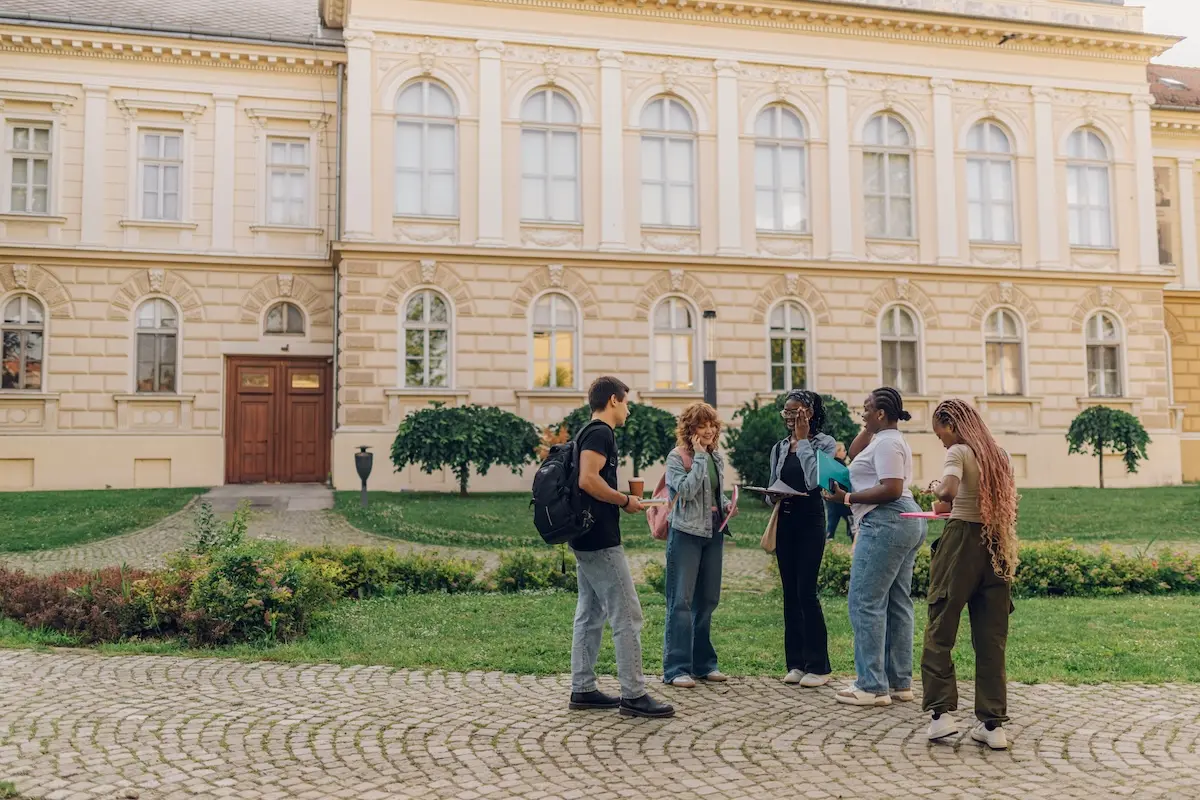 full-length-shot-of-diverse-students-standing-at-c-2026-01-09-10-41-09-utc